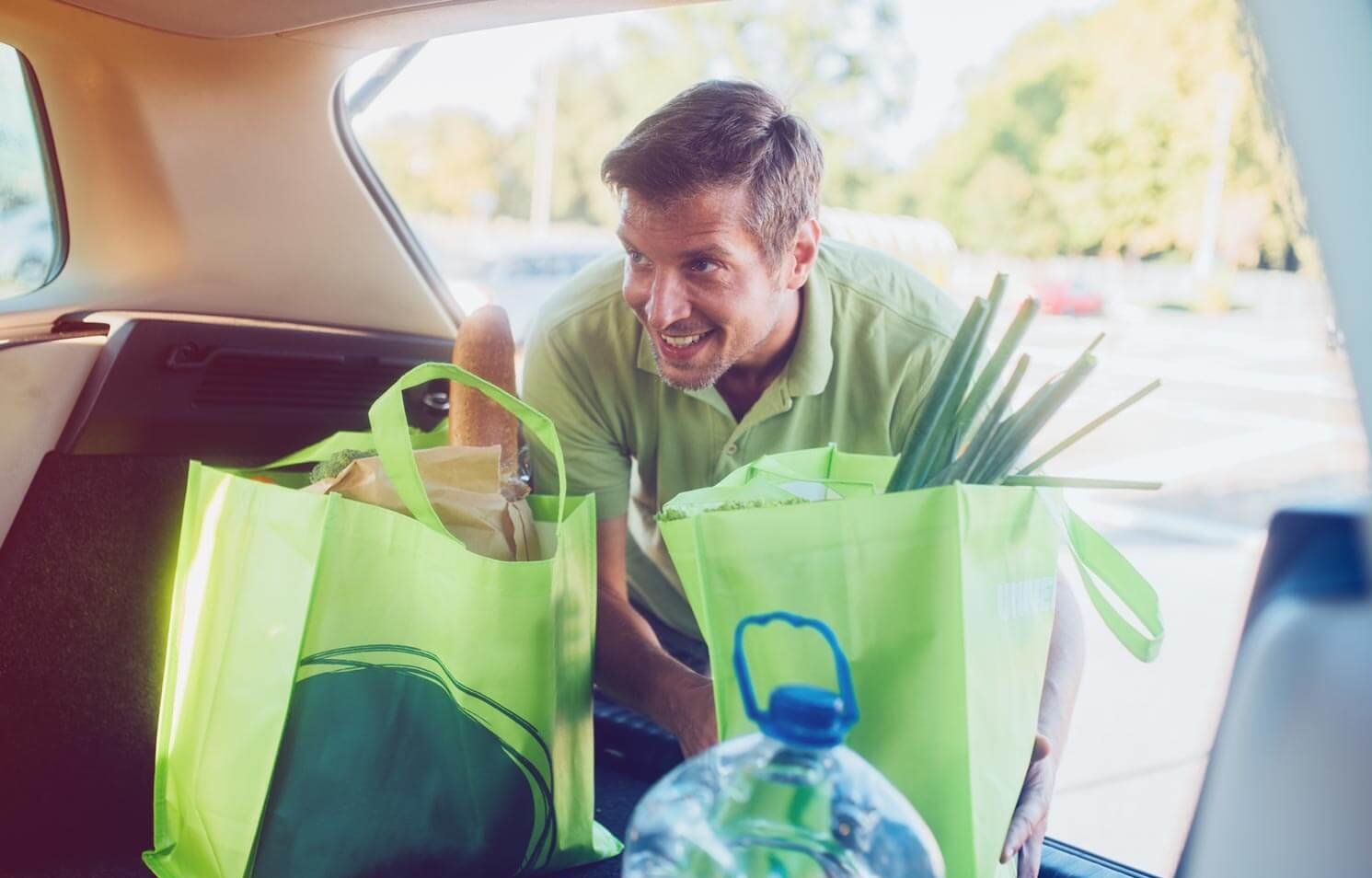 person loading groceries into car