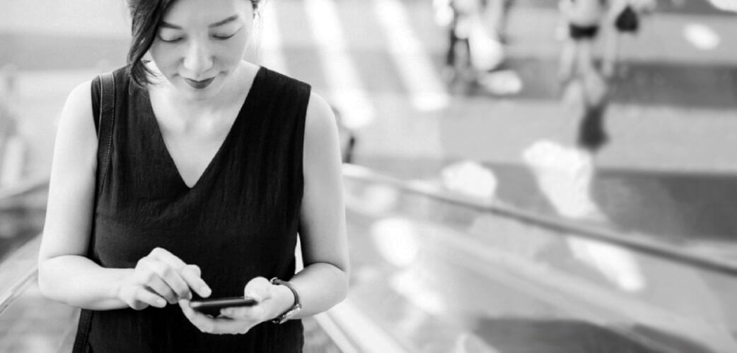 person looking down at mobile phone